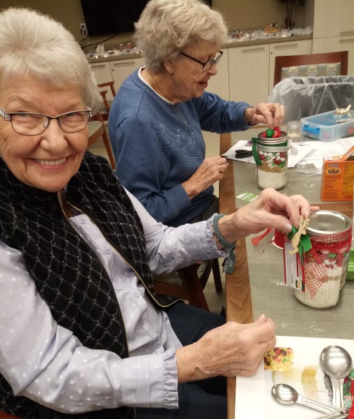 Residents at Burien making cookie jar craft.