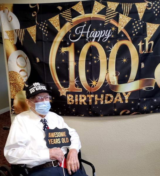 Frank, a Siena Hills resident, takes a photo in front of his 100th birthday sign.