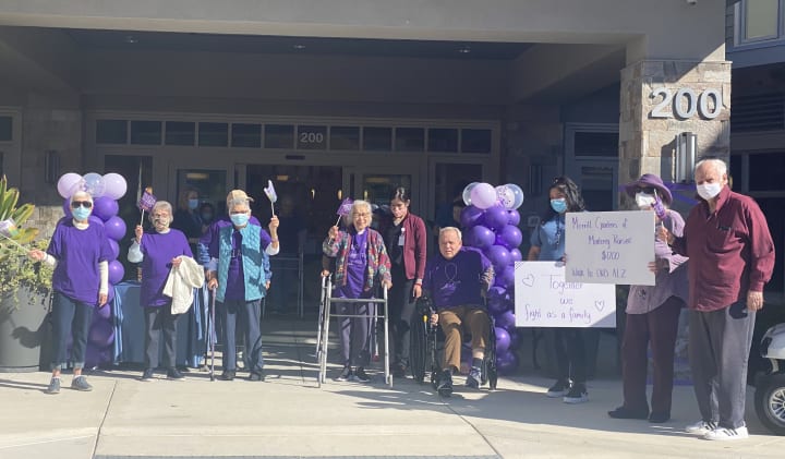 Monterey (CA) residents pose outside the community before their walk.