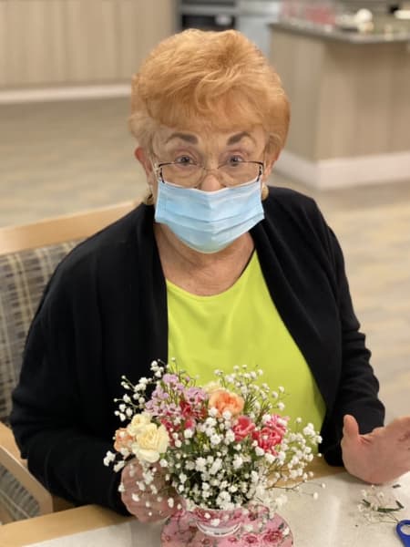 A resident at Monterey shows off her teacup bouquet