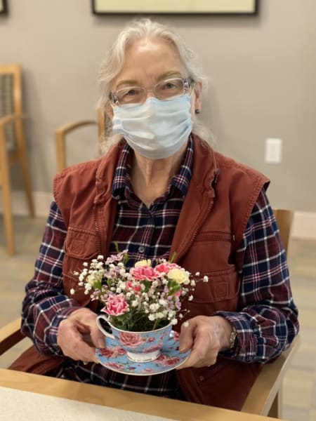 A resident at Monterey shows off her teacup bouquet