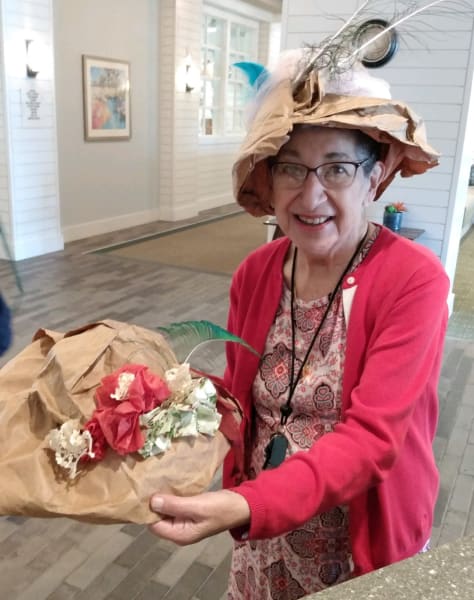 A Carolina Park resident decorates her paper bag hat with gorgeous flowers.