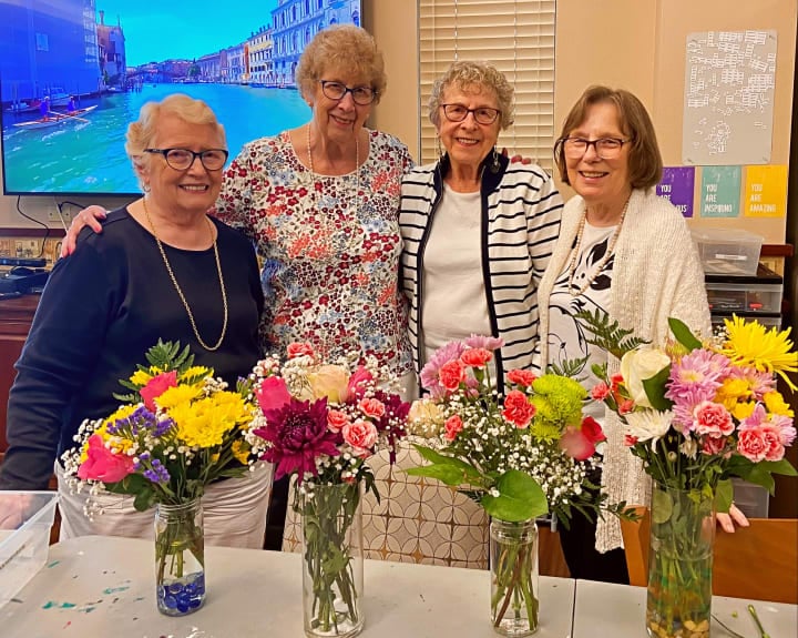 Tacoma residents gather around to show off their brand new floral arrangements.