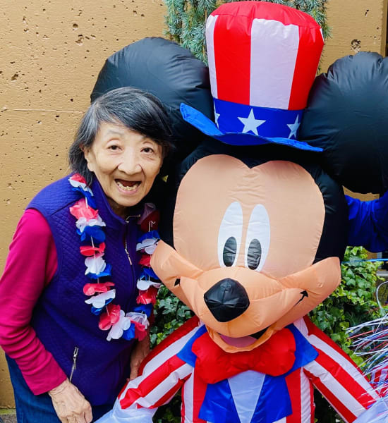 A First Hill (WA) poses next to a festive Mickey Mouse for Independence Day.