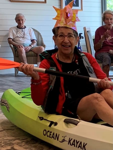 A Carolina Park resident competes in the kayak bean bag toss event!