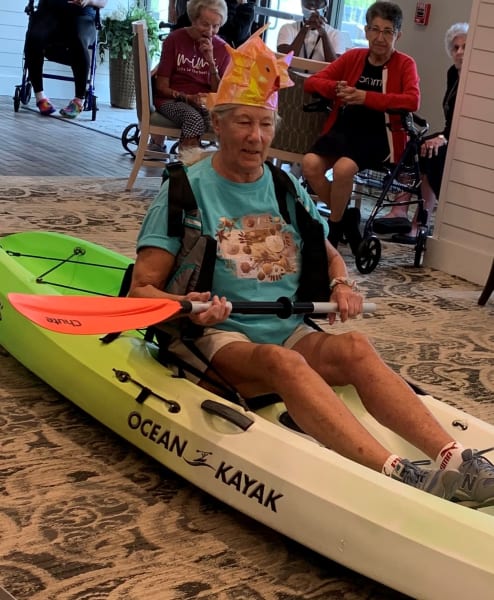 A Carolina Park resident competes in the kayak bean bag toss event!