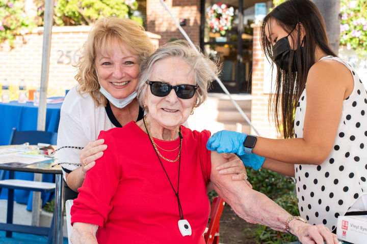 A Bankers Hill resident is all smiles as she gets her COVID-19 Booster Shot.