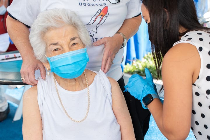 A Bankers Hill resident is all smiles as she gets her COVID-19 Booster Shot.