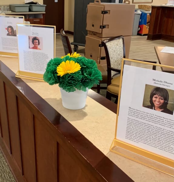 Women's History Month bios and photos displayed on the counters.