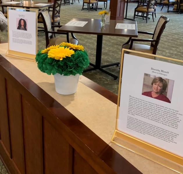 Women's History Month bios and photos displayed on the counters.