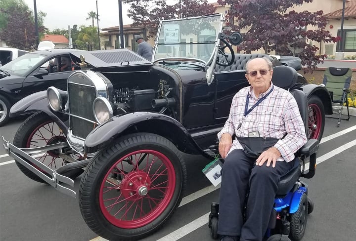 Resident next to classic car at Merrill Gardens at Rancho Cuamonga