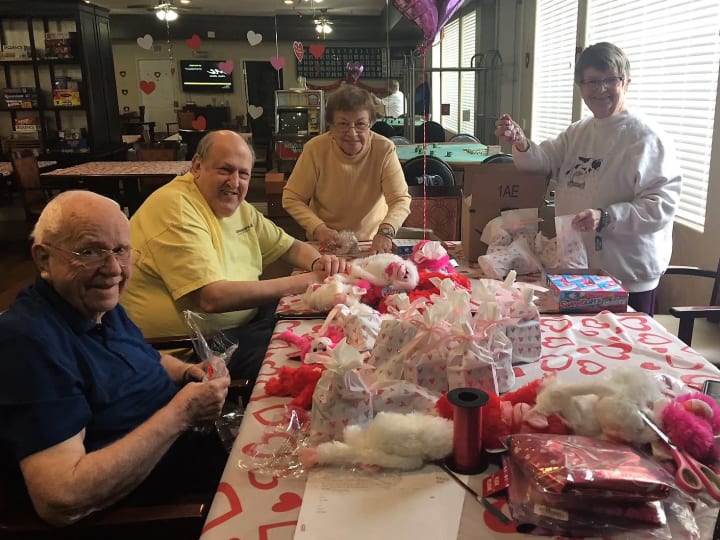 Friends making balloon grams for friends on Valentine's Day at Merrill Gardens at Siena Hills