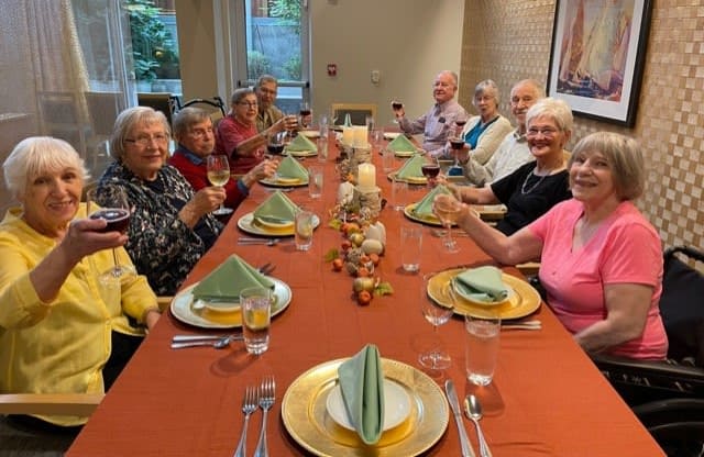 Ballard residents gather around the table to celebrate the community's September birthdays!