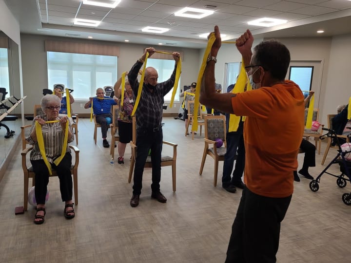 Harry leads a group of West Covina residents in band work.