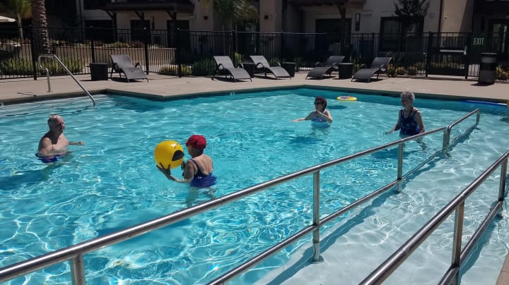 Residents enjoying the pool at Merrill Gardens at Rancho Cucamonga