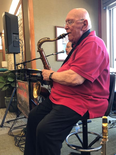 resident playing the sax for the community