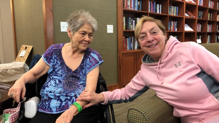 Residents holding hands listening to music